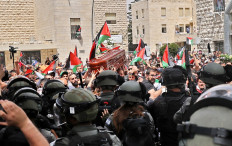 Violence erupts between Israeli security forces and Palestinian mourners carrying the coffin of slain Al-Jazeera journalist Shireen Abu Akleh out of a hospital in Jerusalem, on May 13, 2022.