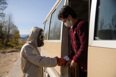 In this file photo taken on October 29, 2020 a 'hygienic and anti-epidemic official' checks the body heat of a traveller aboard a bus as part of preventative measures against the COVID-19 coronavirus, at a roadblock at the entrance to Wonsan, Kangwon Province. North Korea on May 12, 2022 confirmed its first-ever case of Covid-19, with state media declaring it a 