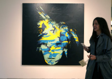 A person walks past Andy Warhol’s Self Portrait during the New York press preview on May 6 for the Macklowe Collection at Sotheby's in the United States.