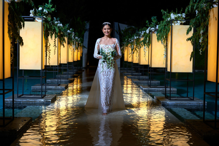 Magical moment: A model walks down the aisle on water at The Cove, the dreamy new wedding venue at Renaissance Bali Nusa Dua Resort. (Courtesy of Renaissance Bali Nusa Dua Resort)