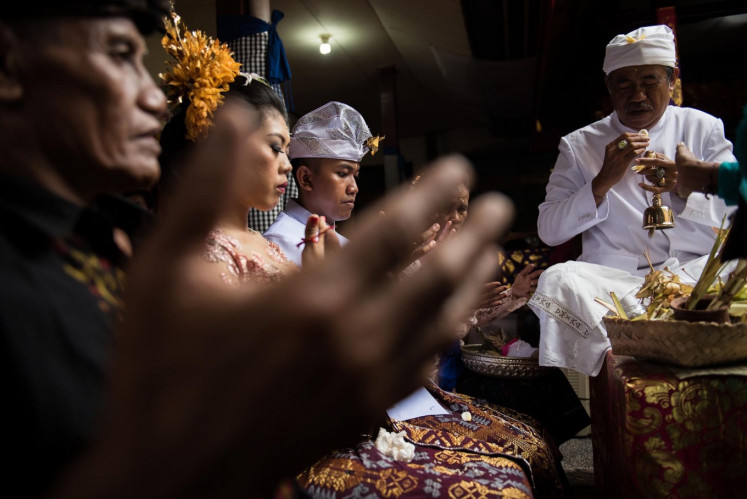 Solemn: A traditional Balinese wedding in Denpasar. Suffused in centuries-old tradition and uniting communities, it is bound by complex rules, such as the taboo against intercaste marriages. (JP/Anggara Mahendra).
