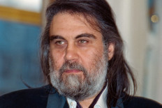 A picture taken on October 20, 1992 shows Greek musician and composer Vangelis Papathanassiou, known as Vangelis, posing at the French Culture Ministry after receiving a decoration. Vangelis, the Greek composer of soundtracks for 