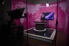 In this photo taken on February 18, 2019, Afghan presenter Diba Akbari, 21, takes part in a live news broadcast for Zan TV (Women's TV) in Kabul. Afghanistan's population -- estimated at 35 million -- is overwhelmingly young, with 63.7 percent under the age of 25. Millions have grown up in cities, swollen by refugees during the years of fighting. 