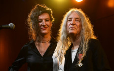 US singer-songwriter Patti Smith, accompanied by her daughter pianist Jesse Paris Smith, performs on stage after receiving the highest French order of merit 