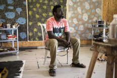 Contemporary Senegalese artist, Omar Ba, poses for a portrait at his workshop in Sangalkam on May 09, 2022.