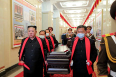This picture taken on May 22, 2022 shows North Korean leader Kim Jong Un (L) carrying the coffin of late Hyon Chol Hae, Marshal of the Korean People's Army during his funeral in Pyongyang.