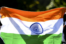 An Indian cricket fan waves the national flag during the Women's Cricket World Cup match between South Africa and India at Hagley Oval in Christchurch on March 27, 2022.