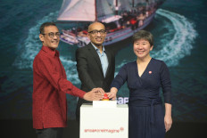 John Conceicao, executive director of Singapore Tourism Board (left),  Anil Kumar Nayar, Singapore's ambassador to Indonesia (center) and Juliana Kua, assistant CEO of Singapore Tourism Board's International Group pose during the launch of the 'SingapoReimagine' campaign. 