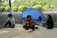 High school students hang out at a park in Beijing on May 21, 2022.