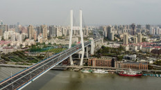 An aerial view shows the Nanpu Bridge over the Huangpu River in the direction of Pudong district in Shanghai, China, on March 30, 2022.