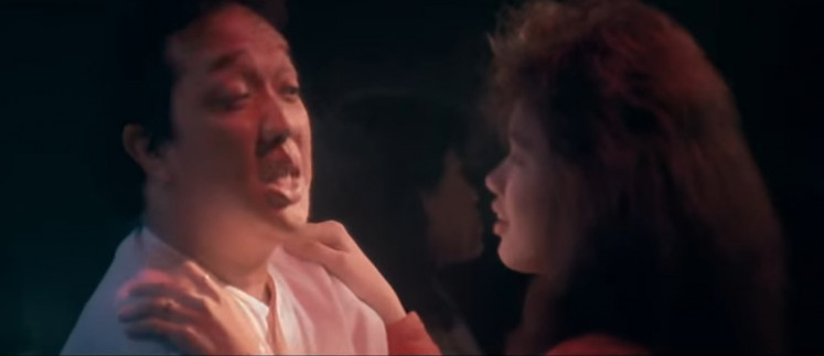 On TV: The late Didi Petet (left) plays the feminine Emon in the 1988 film 'Catatan Si Boy 2.' (YouTube/FLIK TV)