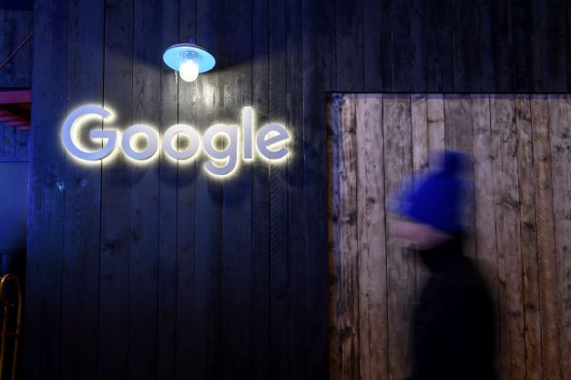 Big tech: A man passes by a Google sign at the company’s stand during the annual meeting of the World Economic Forum in Davos on Jan. 21, 2020. The world’s largest economies have agreed on a mechanism to ensure that multinational enterprises pay an agreed-upon minimum tax.