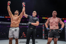Referee Olivier Coste (center) raises Marcus “Buchecha” Almeida’s hand to declare the Brazilian mixed martial artist a winner in his bout against Simon Carson at ONE 158 on June 3.  