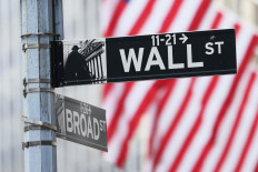 A Wall Street sign is seen outside of the New York Stock Exchange during morning trading on June 08, 2022 in New York City, US.