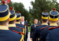Romanian President Klaus Iohannis and French President Emmanuel Macron review honour guards during a welcome ceremony ahead of their meeting, at the Mihail Kogalniceanu Air Base, near the city of Constanta, Romania June 15, 2022. 
