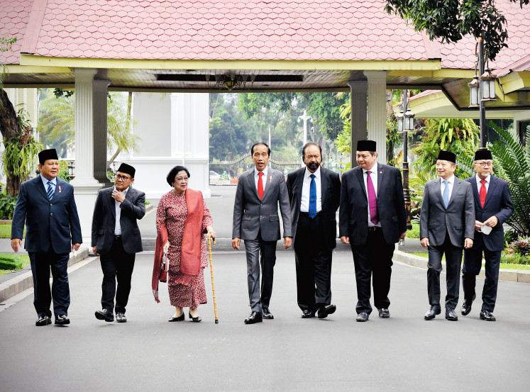 President Joko "Jokowi" Widodo (fourth left) walks with National Mandate Party (PAN) chairman Zulkifli Hasan (right) and Indonesian Democratic Party of Struggle (PDI-P) chairwoman Megawati Soekarnoputri (third left), along with other party leaders from his ruling coalition, to attend a luncheon at the State Palace in Central Jakarta on June 15, 2022, prior to the inauguration of new Cabinet ministers.