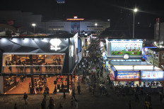 Visitors browse exhibition pavilions at the opening of the 53rd Jakarta Fair in Kemayoran, Central Jakarta, on Jun 9, 2020.
