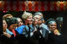 Supporters of Colombian left-wing presidential candidate Gustavo Petro watch him speaking on a screen in Medellin, Colombia, on June 19, 2022 after the presidential runoff election. Ex-guerrilla Gustavo Petro was elected the first ever left-wing president of crisis-wracked Colombia on Sunday after beating millionaire businessman Rodolfo Hernandez in a tense and unpredictable runoff election.