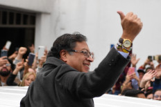 Colombian left-wing presidential candidate Gustavo Petro gives the thumb up as he arrives at a polling station during the presidential runoff election in Bogota, on June 19, 2022. Colombians vote for a new president in an election filled with uncertainty, as former guerrilla Gustavo Petro and millionaire businessman Rodolfo Hernandez vie for power in a country saddled with widespread poverty, violence and other woes.