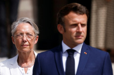 French President Emmanuel Macron (right) and French Prime Minister Elisabeth Borne (left) attend a ceremony marking the 82nd anniversary of late French General Charles de Gaulle's resistance call of June 18, 1940, at the Mont Valerien memorial in Suresnes near Paris, on June 18, 2022. 