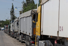 Trucks loaded with grain wait in a queue near Izmail, in the Odessa region on June 14, 2022, amid the Russian invasion of Ukraine. In the Ukrainian port of Izmail, on the Danube river that marks the border with Romania, rows of trucks filled with grain stand in line.