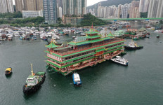 This file photo taken on June 14, 2022 shows an aerial view of Hong Kong's Jumbo Floating Restaurant, an iconic but aging tourist attraction designed like a Chinese imperial palace, being towed out of Aberdeen Harbour.