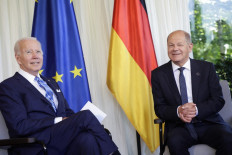 German Chancellor Olaf Scholz (right) and US President Joe Biden talk at Elmau Castle, southern Germany, as they meet for bilateral talks on June 26, 2022, at the beginning of a summit of the Group of Seven rich nations (G7). G7 leaders will be under pressure to hold fast to climate pledges when they meet in Bavaria from June 26 to 28, as Russia's energy cuts trigger a dash back to planet-heating fossil fuels.