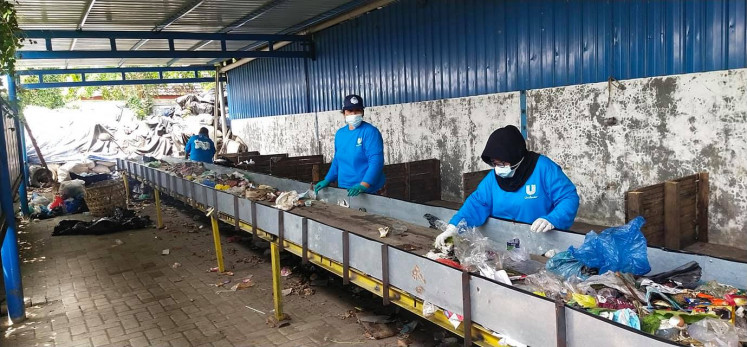 Doing the work: Several women sort plastic waste, which is a part of the waste bank program in Medan. (Courtesy of Armawati Chaniago)