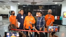 Workers joined by lawyers representing various labor organizations speak to the press at the Constitutional Court on June 27, 2022, after submitting a petition for a judicial review of the 2011 Law on the drafting of laws and regulations.