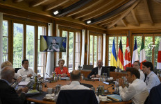 (From C, clockwise) Germany's Chancellor Olaf Scholz, US President Joe Biden, Britain's Prime Minister Boris Johnson, Japan's Prime Minister Fumio Kishida, European Commission President Ursula von der Leyen, European Council President Charles Michel, Italy's Prime Minister Mario Draghi, Canada's Prime Minister Justin Trudeau and France's President Emmanuel Macron have taken seat at a round table as Ukraine's President Volodymyr Zelensky addresses G7 leaders via video link during their working session on June 27, 2022 at Elmau Castle, southern Germany, where the German Chancellor hosts a summit of the Group of Seven rich nations (G7). G7 leaders are under pressure to hold fast to climate pledges when they meet in Bavaria from June 26 to 28, as Russia's energy cuts trigger a dash back to planet-heating fossil fuels.