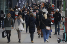 People are seen in a shopping area in Berlin on Feb. 18, 2022.
