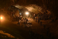In this file photo taken on June 26, 2018 Thai soldiers relay electric cable deep into the Tham Luang cave at the Khun Nam Nang Non Forest Park in Chiang Rai during a rescue operation for a missing children's football team and their coach. The dramatic rescue of 12 youth football players and their coach from a flooded cave in Thailand in 2018, a captivating operation already revisited in an award-winning documentary, is now getting the big-screen dramatic treatment from Ron Howard.