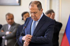 Russia's Foreign Minister Sergei Lavrov checks his watch during a joint press conference with his Iranian counterpart at the foreign ministry headquarters in Iran's capital Tehran on June 23, 2022. 