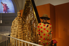Exploring Africa: Moroccan fashion designer Artsi Ifrach poses for a photograph next to his creation, A Dialogue Between Cultures, during a photo call on Monday for the Africa Fashion exhibition at the Victoria and Albert Museum in London.