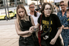 People react in front of the Fields shopping center, after Danish police said they received reports of a shooting at Fields shopping center, in Copenhagen, Denmark, July 3, 2022.  