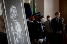 A mural by anonymous British street artist Banksy is seen during the ceremony to return to France at the French embassy in Rome
