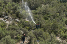 Greek newly established Special Unit for Wildfire response (EMODY) take part during a training session to prevent and fight wildfires, in Magoula central Greece, on June 30, 2022. In Magoula, on the outskirts of Athens, on a plot of land that still bears the traces of last summer's fires, a team of European firefighters is training with their Greek counterparts to prepare for the fire season and avoid the worst.
