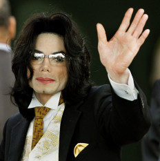 Still controversial: Michael Jackson waves as he arrives on June 3, 2005 at the Santa Barbara County courthouse in Santa Maria, California. Sony and Jackson’s estate announced on July 7 that they were removing three of the late singer’s songs from streaming sites amid ongoing claims that they were sung by someone else.