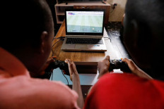 Ready to play: Udom Ukeme, 11, and his brother, Udom Idongesit, 13, play a Vikseen Virtual video game, at their home in Ogun State, Nigeria, on June 23.