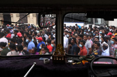 People crowd to visit Sri Lankan President Gotabaya Rajapaksa's official residence in Colombo on July 11, 2022, after it was overrun by anti-government protestors. Millions of rupees in cash left behind by Sri Lanka's president when he fled his official residence was handed over to a court on July 11 after being turned in by protestors, police said as a succession battle got under way.
