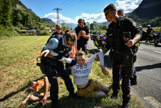 French gendarmes remove environmental protestors of the movement 'Derniere Renovation' from the race route during the 109th edition of the Tour de France cycling race in the French Alps, on July 12, 2022.