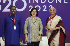 (Front left to right) South African Finance Minister Enoch Godongwana, Finance Minister Sri Mulyani Indrawati and Indian Finance Minister Nirmala Sitharaman pose for photo prior a side event on the G20 Finance Ministers and Central Bank Governors Meeting in Nusa Dua, Bali on July 14, 2022. 
