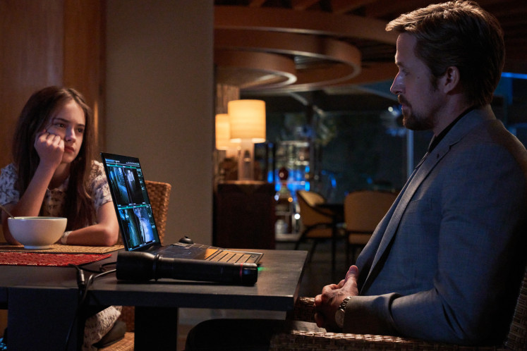 Family above all: Ryan Gosling's character Six (right) takes care of his boss' niece Claire, played by Julia Butters, in 'The Gray Man'. (Netflix/Courtesy of Paul Abell)