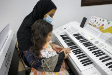From the basics: A child receives a keyboard lesson on June 11 at the Yamaha Music Centre in Riyadh, Saudi Arabia, which has become possible as the government started easing some social restrictions in recent years.