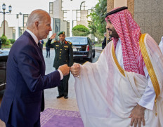 A handout picture released by the Saudi Royal Palace on July 15, 2022, shows Saudi Crown Prince Muhammad bin Salman (right) bumps fists with US President Joe Biden at Al-Salam Palace in the Red Sea port of Jeddah. 
