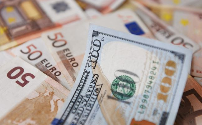 A US$100 bill lies on top of euro bills in Bogota on July 12. 