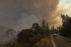 Destroyed property is left in its wake as the Oak Fire chews through the forest near Midpines, northeast of Mariposa, California, on July 23, 2022. 