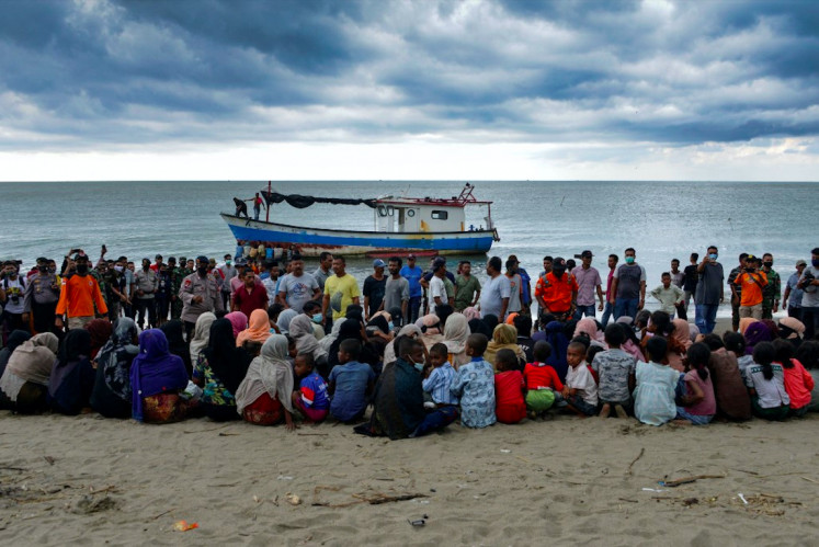 Surviving: Evacuated Rohingya people from Myanmar sit on the shorelines of Lancok village, in Indonesia's North Aceh regency, Special Region of Aceh, on June 25, 2020. Nearly 100 Rohingya from Myanmar, including 30 children, have been rescued from a rickety wooden boat off the coast of Indonesia's Sumatra island, a maritime official said. (AFP/Chaideer Mahyuddin)