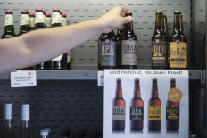 Beer bottles named (L to R) Grandma, Grandpa, Hellmut and Hellga, produced in the brewery of the retirement home in Atzgersdorf in Vienna on July 21, 2022 stand in the refrigerated shelf in the 'market place' of the home.