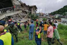 This handout photo taken from the Facebook page of La Trinidad Municipal Police Station shows a rescue team at the site of a collapsed building in La Trinidad, in the province of Benguet on July 27, 2022, after a 7.0-magnitude earthquake hit the northern Philippines. 